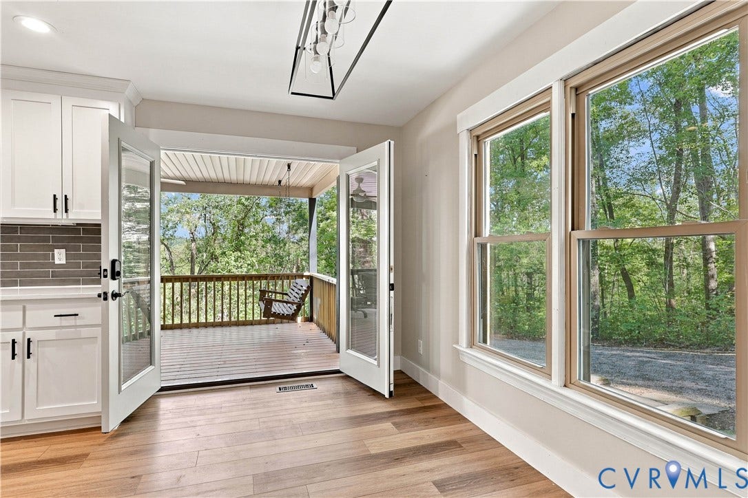 17 River Walk, Cumberland, VA 23027 Wood-finish flooring, white cabinetry with dark hardware, subway tile backsplash, and a modern rectangular light fixture