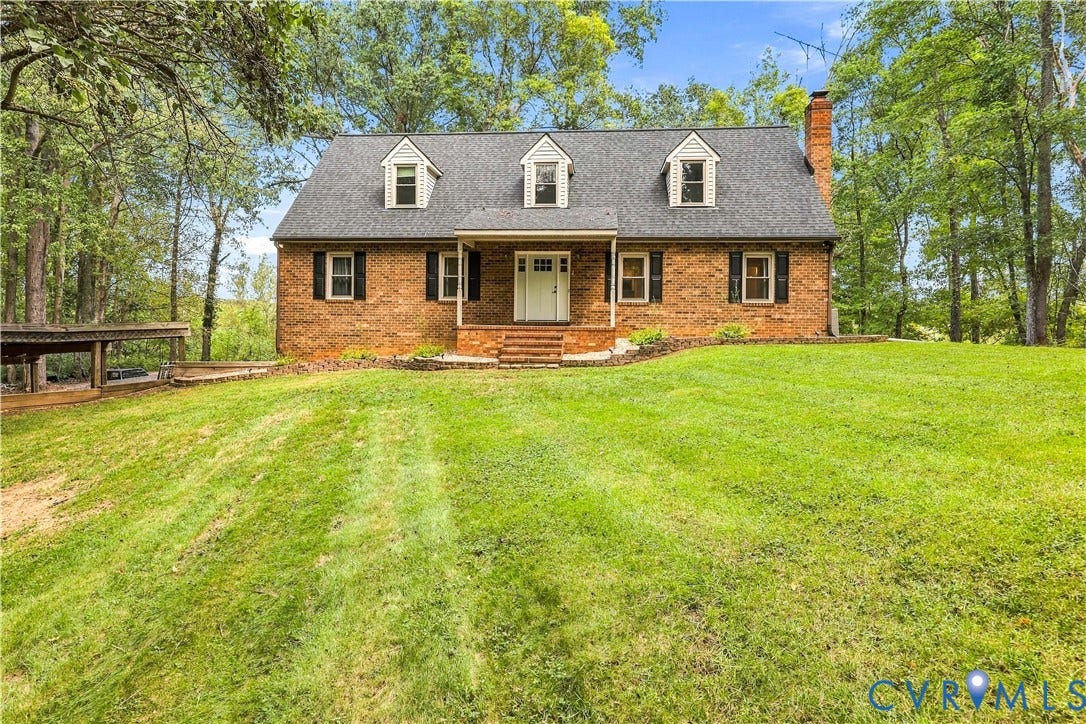 17 River Walk, Cumberland, VA 23027 Brick exterior with a dark shingle roof, multiple dormer windows, and a covered front porch