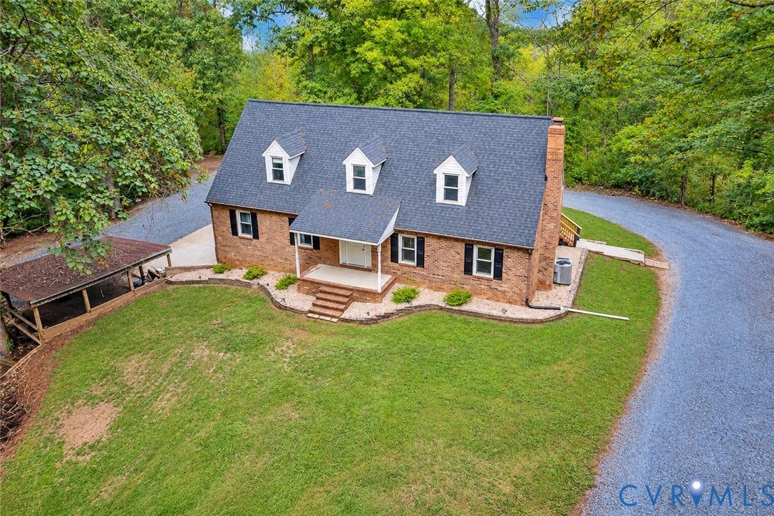 17 River Walk, Cumberland, VA 23027 Brick exterior with a dark shingle roof, three dormer windows, and a covered front porch