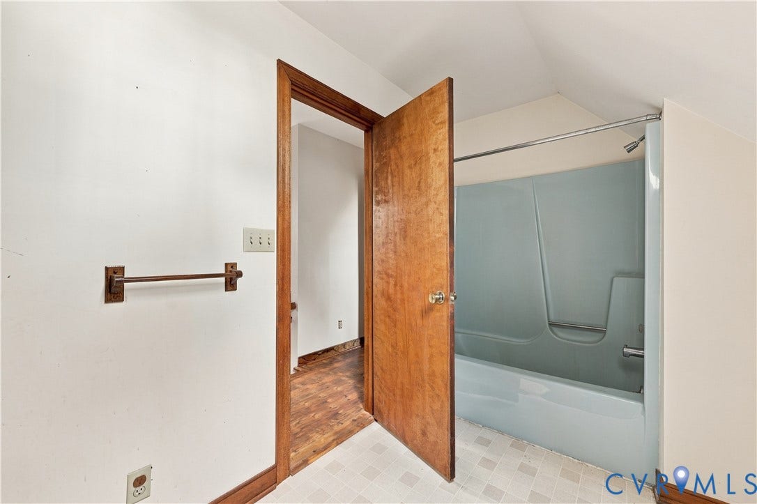 17 River Walk, Cumberland, VA 23027 Bathroom featuring a built-in shower/tub combination with light blue surround and white tile flooring
