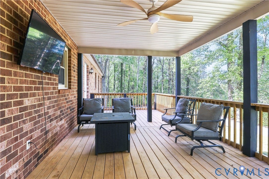 17 River Walk, Cumberland, VA 23027 Covered porch featuring a wood-finish floor, brick exterior, and a ceiling fan