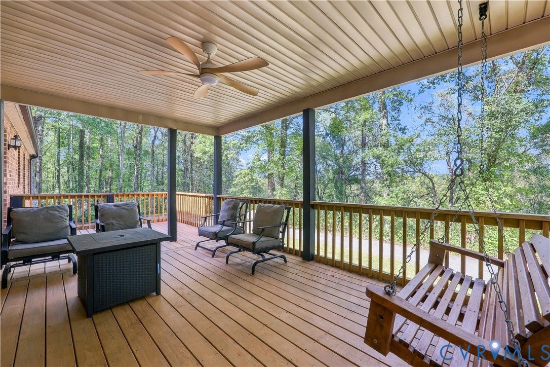 17 River Walk, Cumberland, VA 23027 Expansive covered deck featuring a wood-finish floor, wood railing, and a ceiling fan