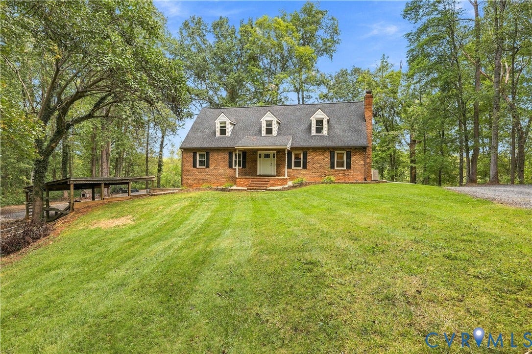 17 River Walk, Cumberland, VA 23027 Brick exterior featuring three dormer windows, a covered front entry, and a prominent chimney