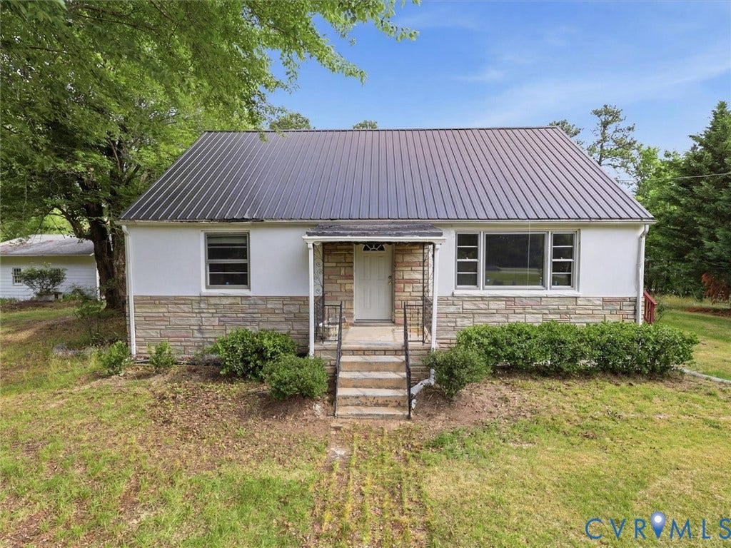 21600 Patrick Henry Highway, Amelia, VA 23083 Metal roof, stone veneer detailing, stucco siding, concrete front steps, mature shrubbery