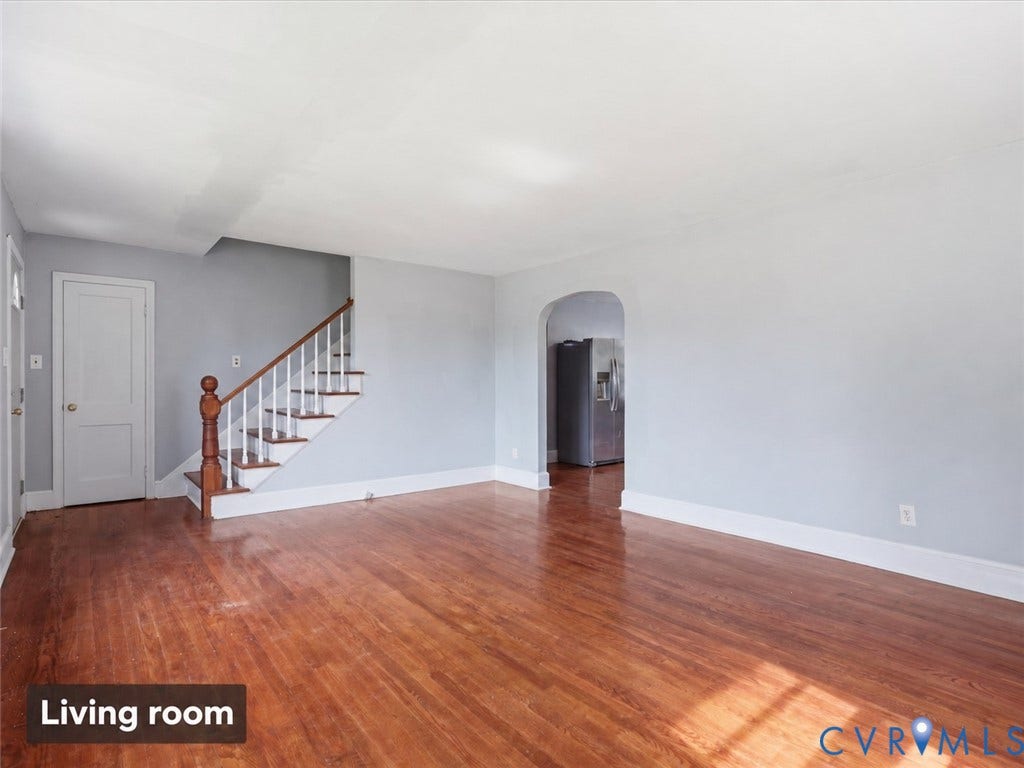 21600 Patrick Henry Highway, Amelia, VA 23083 Hardwood flooring throughout, a staircase with wood newel post and handrail, and an arched doorway