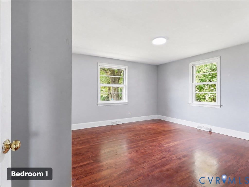 21600 Patrick Henry Highway, Amelia, VA 23083 Wood-finish flooring, two windows with white trim, a flush-mount ceiling light, and light-toned wall paint