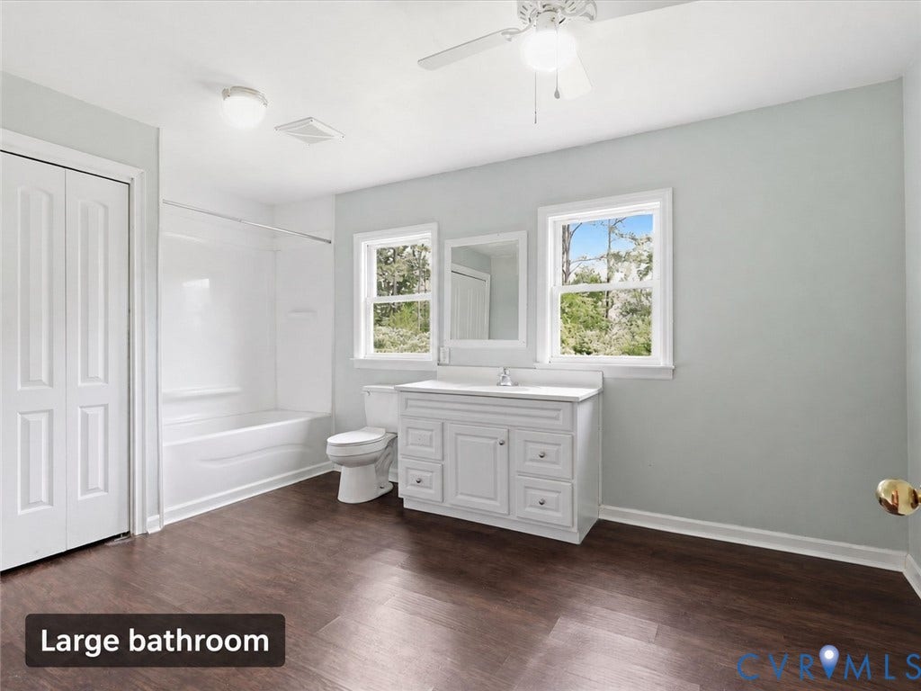 21600 Patrick Henry Highway, Amelia, VA 23083 Spacious bathroom featuring wood-finish flooring, a white vanity with integrated sink, and an included tub-shower combination