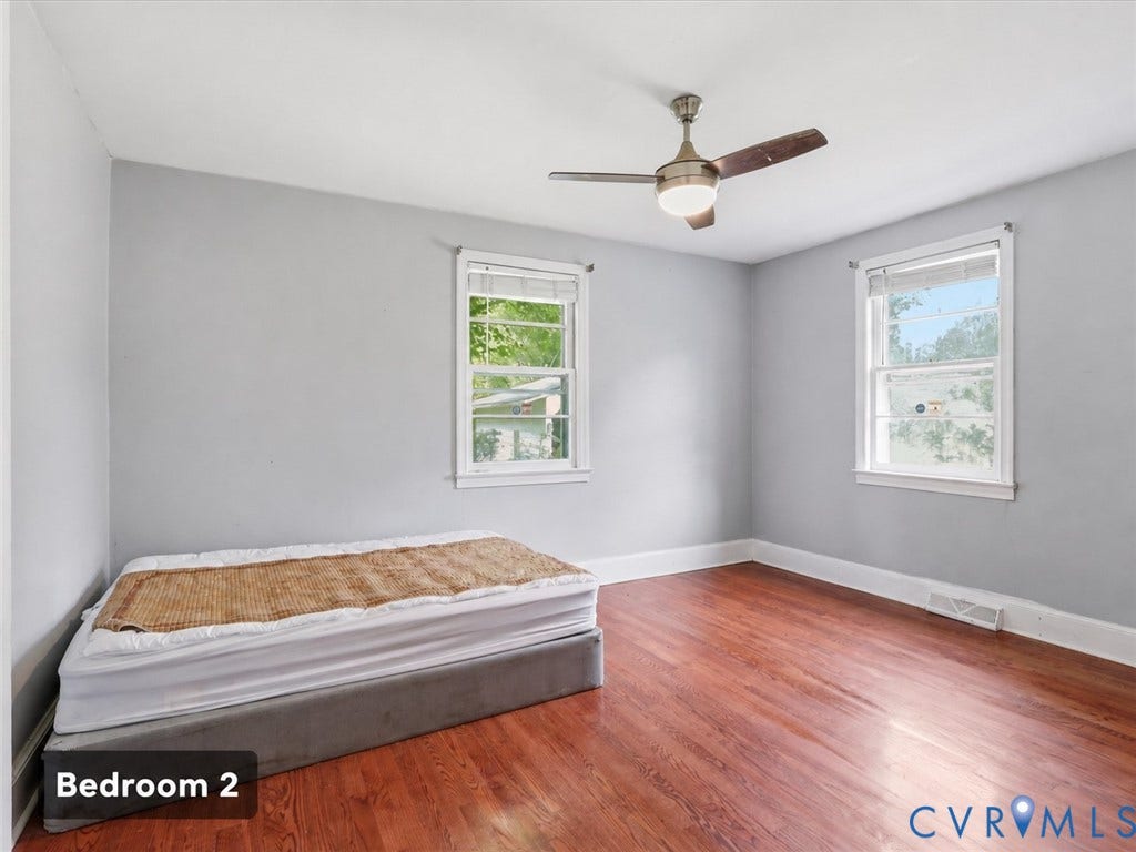 21600 Patrick Henry Highway, Amelia, VA 23083 Hardwood-style flooring, a ceiling fan with integrated lighting, and two windows providing natural illumination