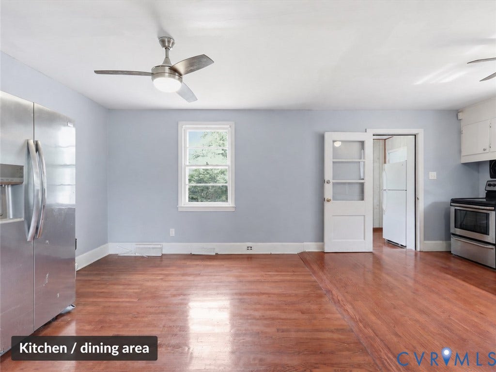 21600 Patrick Henry Highway, Amelia, VA 23083 Wood-finish flooring throughout, stainless steel appliances, white cabinetry, and a ceiling fan with integrated lighting