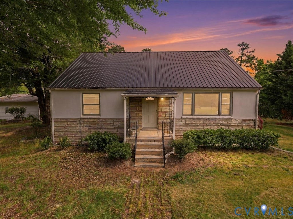 21600 Patrick Henry Highway, Amelia, VA 23083 Exterior featuring a dark metal roof, stone veneer accents, and a concrete entry staircase with wrought iron railings