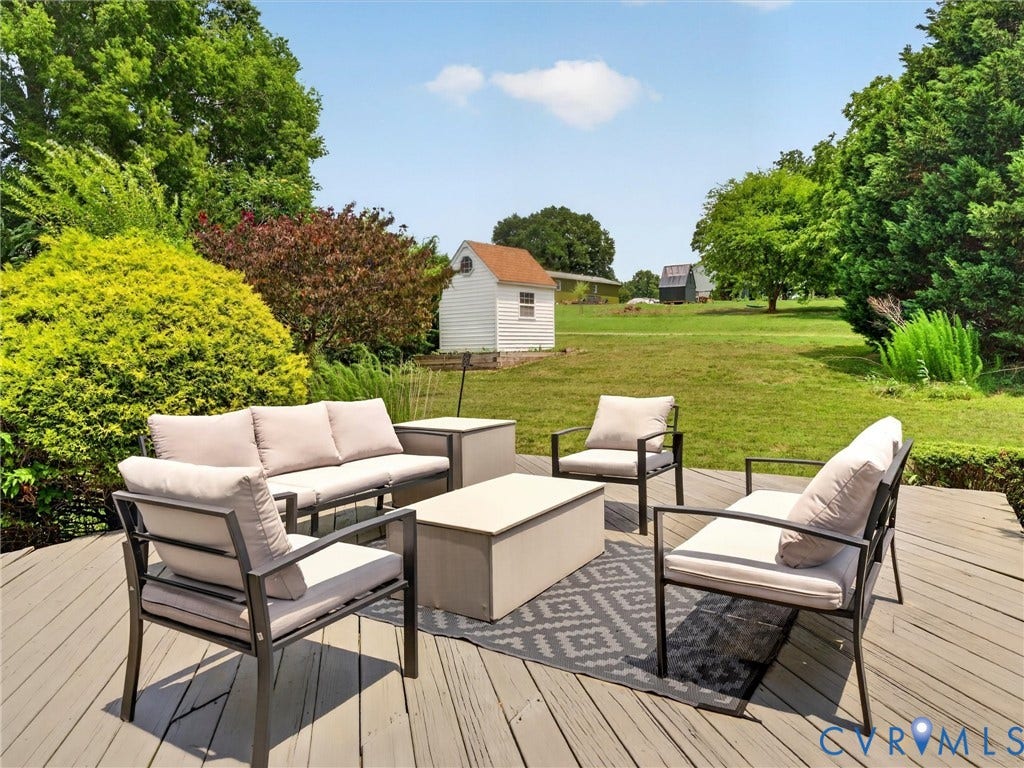 7478 Troub Lane, Elwin Place, Mechanicsville, VA 23111 Spacious outdoor deck with a large lawn area, mature trees, and a detached white shed