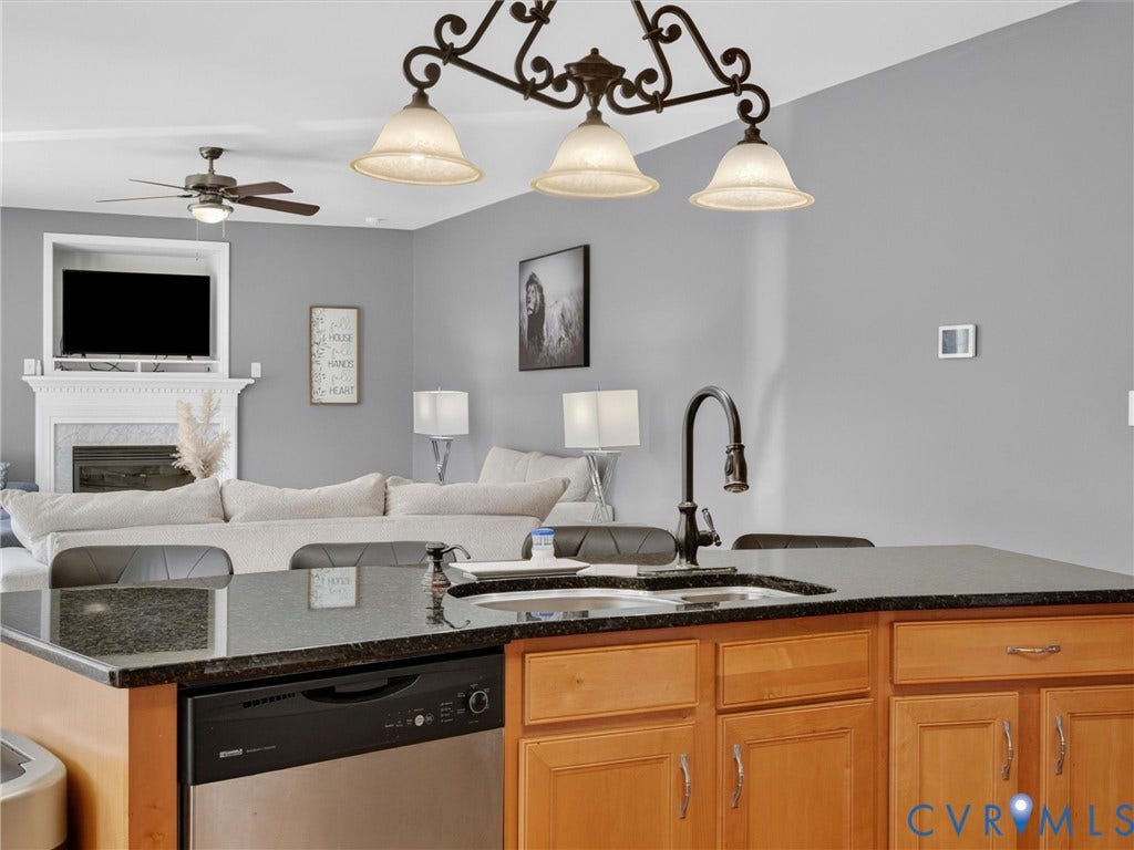 7478 Troub Lane, Elwin Place, Mechanicsville, VA 23111 Kitchen island with dark countertop, integrated sink with gooseneck faucet, and built-in dishwasher
