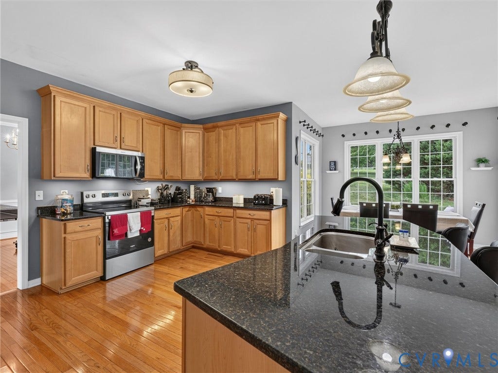 7478 Troub Lane, Elwin Place, Mechanicsville, VA 23111 Wood-finish flooring, stainless steel appliances, dark stone countertops, wood cabinetry, and a black gooseneck faucet