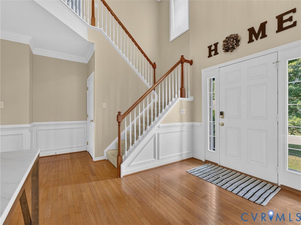7478 Troub Lane, Elwin Place, Mechanicsville, VA 23111 Hardwood flooring, two-story foyer, wainscoting, crown molding, and a dual-level staircase