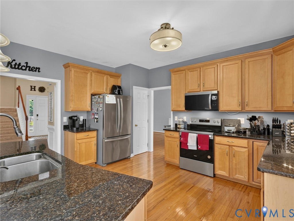 7478 Troub Lane, Elwin Place, Mechanicsville, VA 23111 Kitchen with wood-finish flooring, stainless steel appliances, and dark speckled countertops