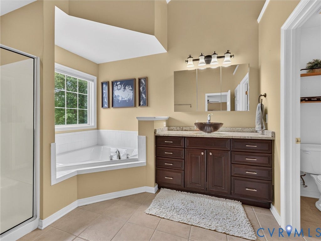 7478 Troub Lane, Elwin Place, Mechanicsville, VA 23111 Spacious bathroom featuring a built-in soaking tub, separate shower enclosure, double vanity with stone-finish countertop, and tile flooring