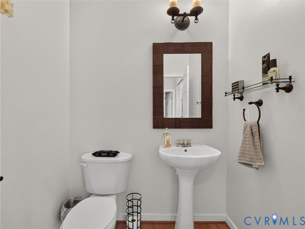 7478 Troub Lane, Elwin Place, Mechanicsville, VA 23111 Pedestal sink with a single-hole faucet, a framed mirror, and a wall-mounted glass shelf