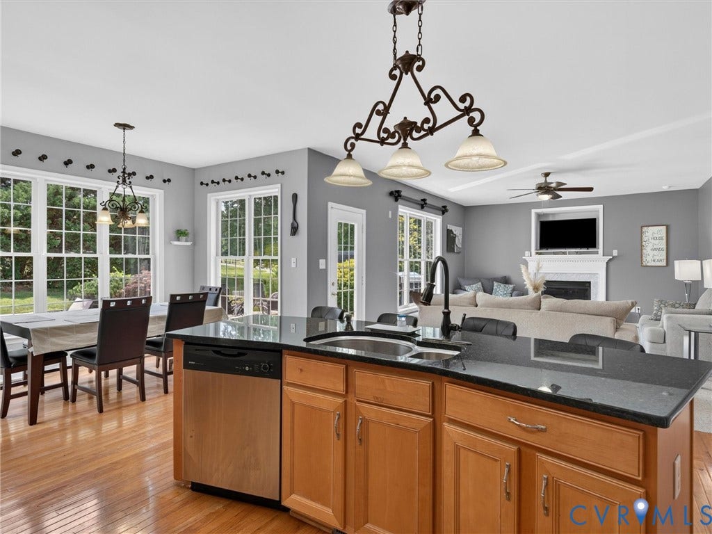 7478 Troub Lane, Elwin Place, Mechanicsville, VA 23111 Kitchen island with dark countertop, stainless steel dishwasher, and wood cabinetry