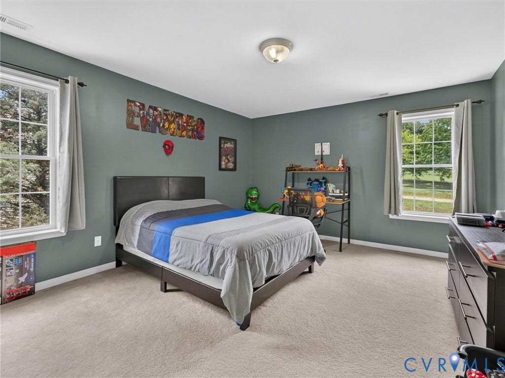 7478 Troub Lane, Elwin Place, Mechanicsville, VA 23111 Wall-to-wall carpeting with multiple large windows and a ceiling-mounted light fixture