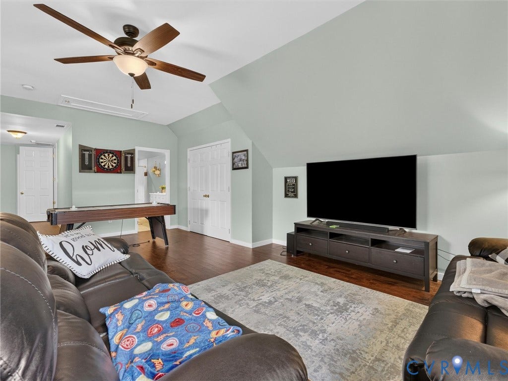 7478 Troub Lane, Elwin Place, Mechanicsville, VA 23111 Wood-finish flooring throughout, featuring a sloped ceiling, a ceiling fan with integrated lighting, and multiple white panel doors