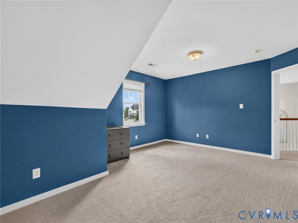 7478 Troub Lane, Elwin Place, Mechanicsville, VA 23111 Carpeted flooring with a window offering natural light, sloped ceiling, overhead flush-mount lighting, and white trim