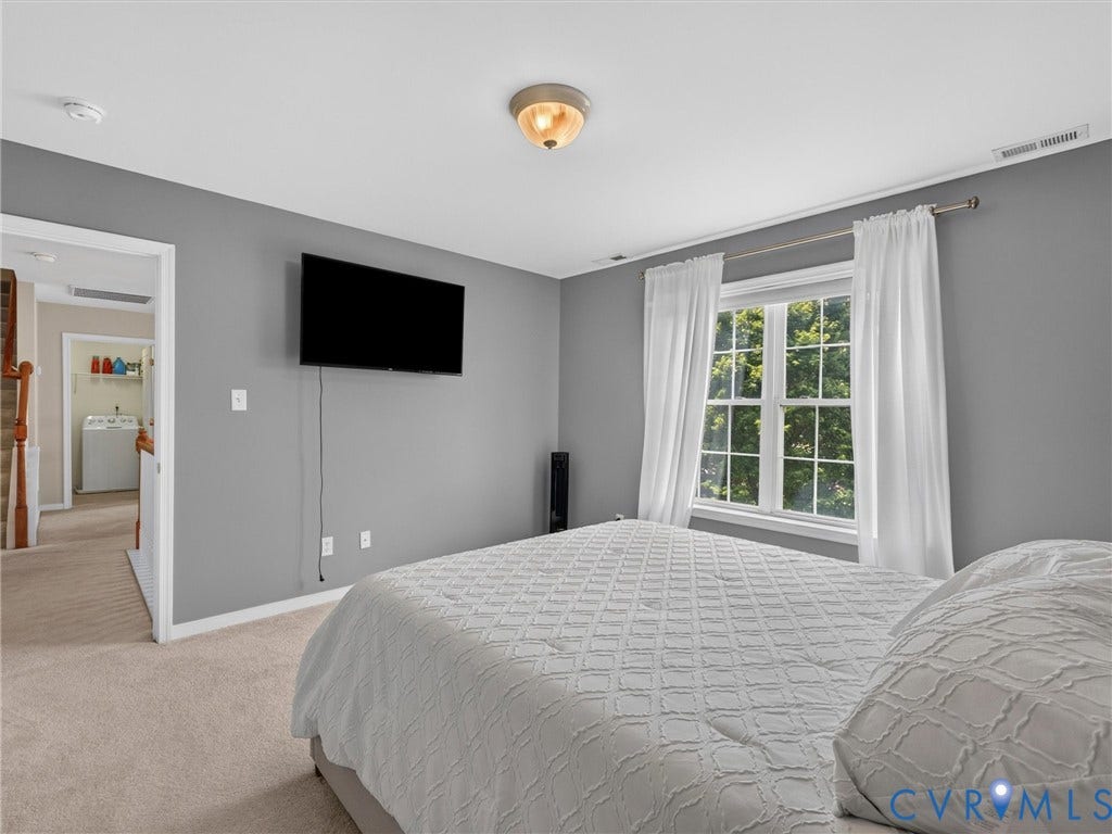 7478 Troub Lane, Elwin Place, Mechanicsville, VA 23111 Carpeted flooring, window with exterior foliage, wall-mounted light fixture, and neutral wall paint