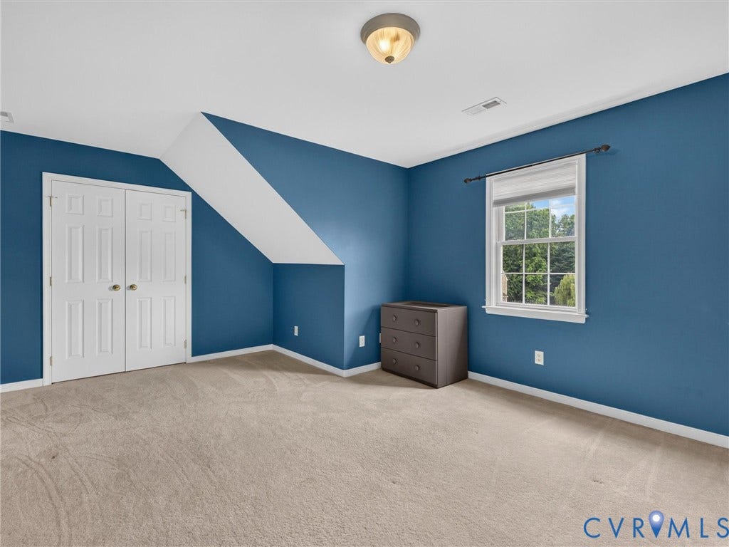 7478 Troub Lane, Elwin Place, Mechanicsville, VA 23111 Carpeted flooring, window with natural light, ceiling-mounted light fixture, white paneled bifold closet doors, and angled ceiling details