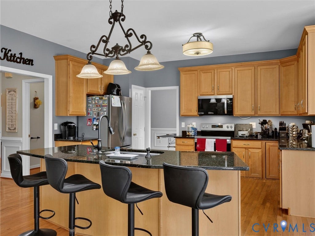 7478 Troub Lane, Elwin Place, Mechanicsville, VA 23111 Kitchen featuring wood-finish cabinetry, black stone countertops, stainless steel appliances, and wood-finish flooring