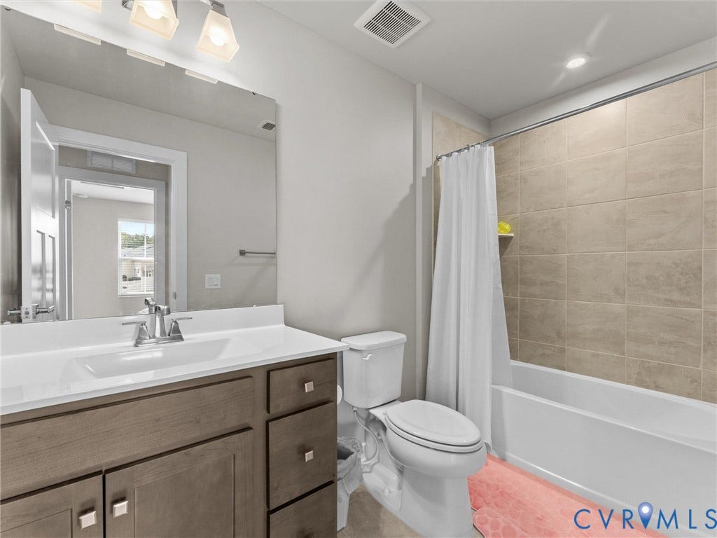 Vanity with an integrated sink, polished chrome faucet, and storage cabinetry