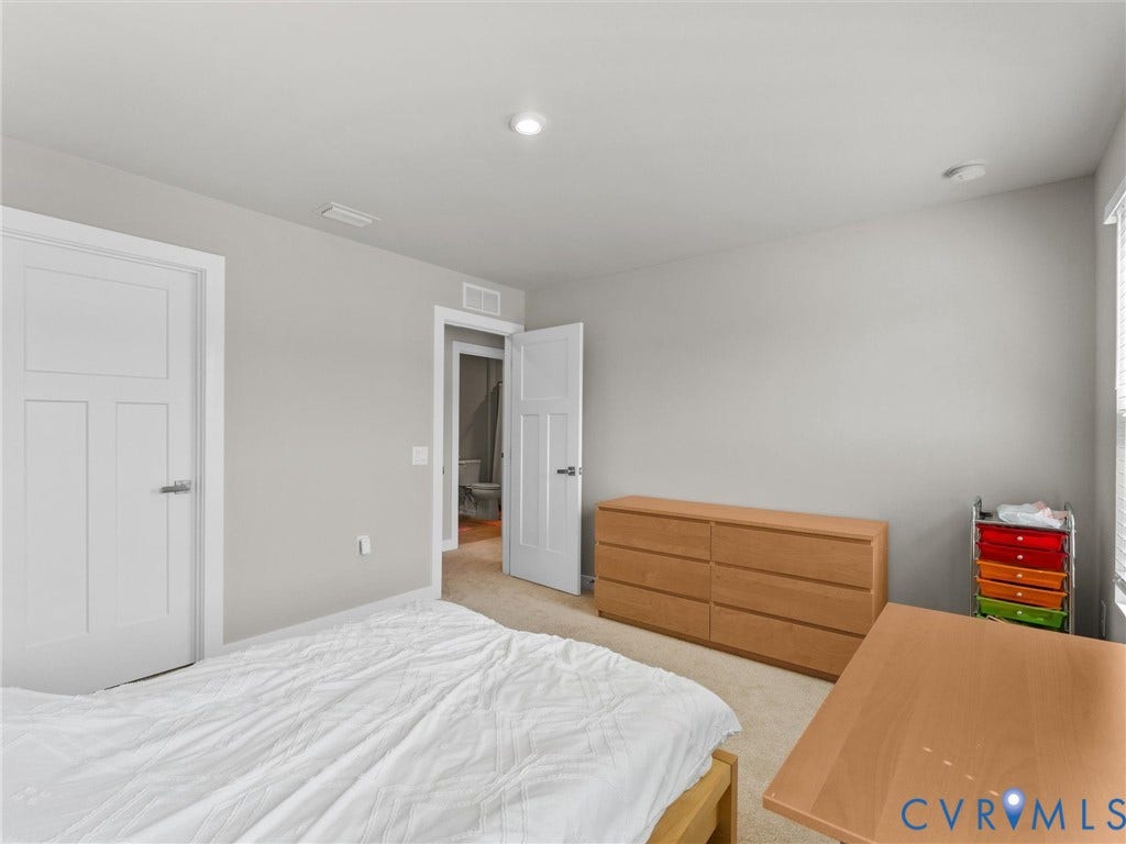 Recessed lighting, light-colored walls, carpeted flooring