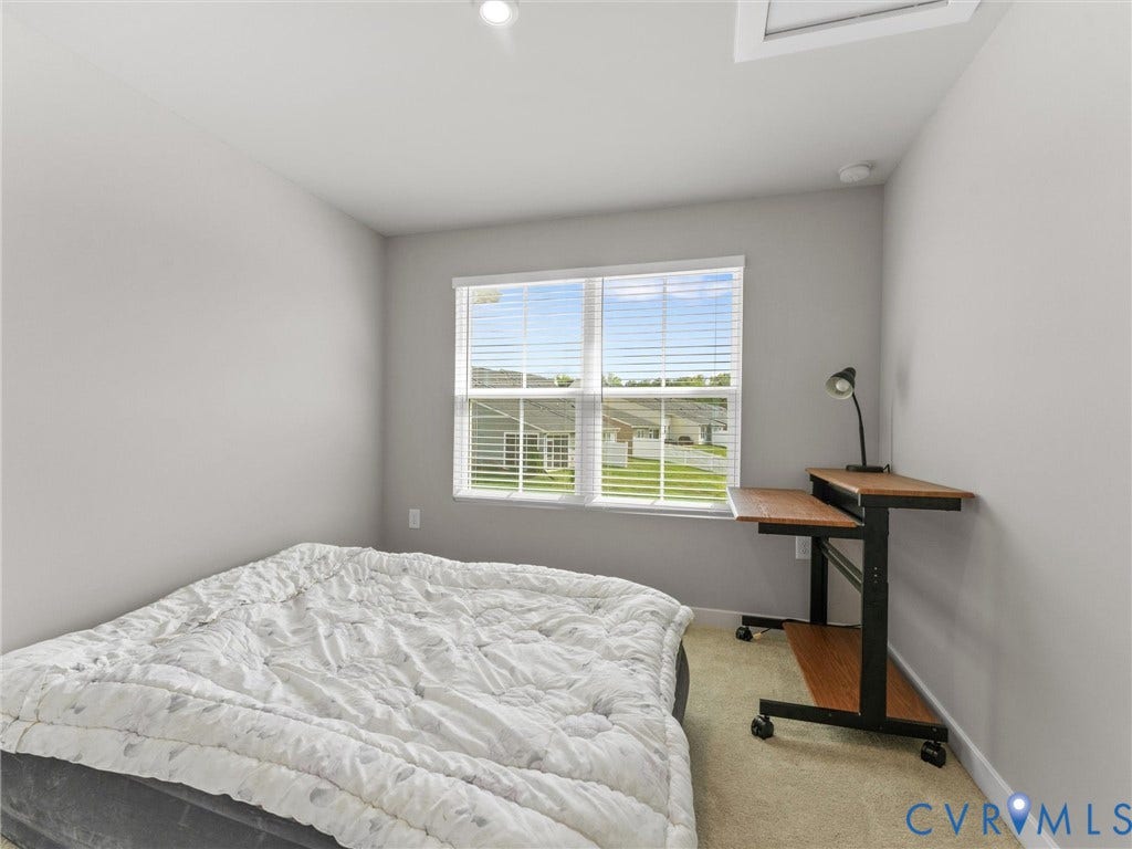 Recessed ceiling lighting, light gray wall finishes, window with horizontal blinds, and carpeted flooring