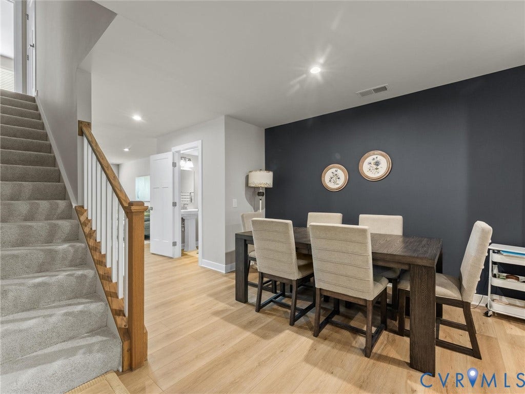 Hardwood-finish flooring, recessed lighting, and a painted accent wall create a refined ambiance
