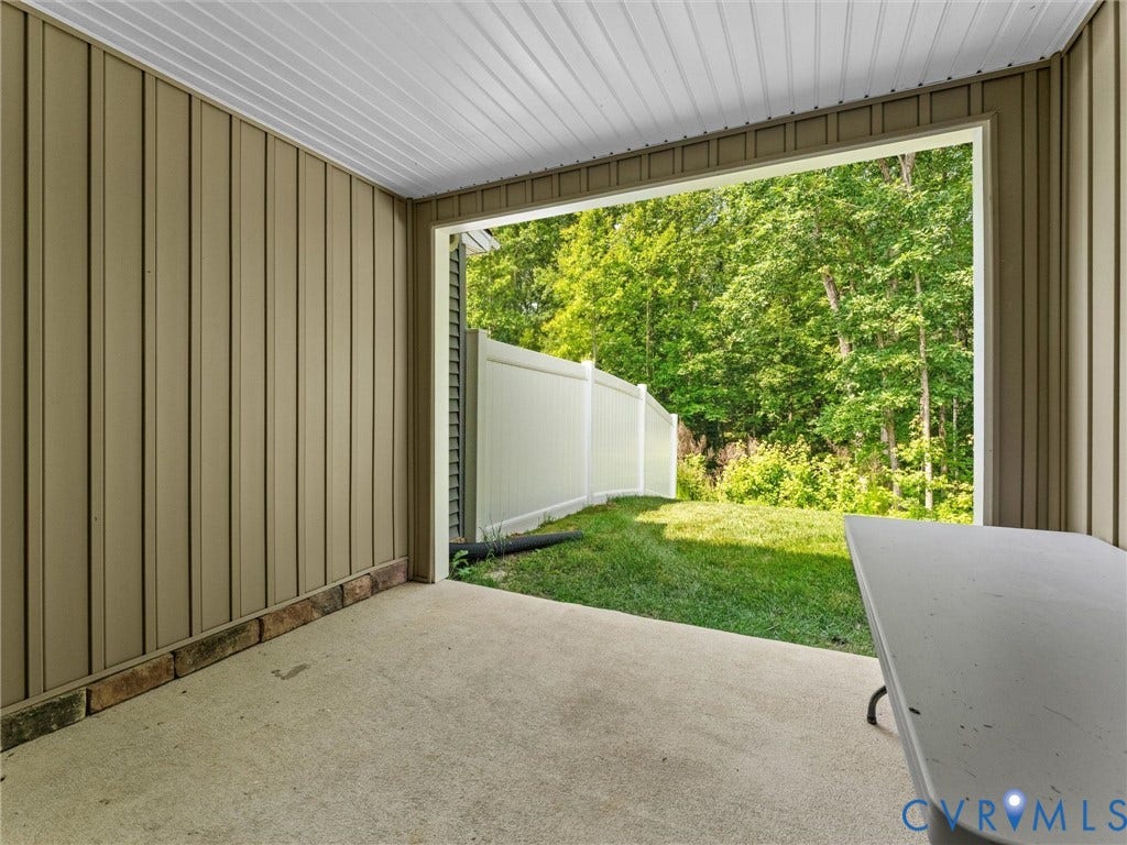 Covered concrete patio with vertical panel siding