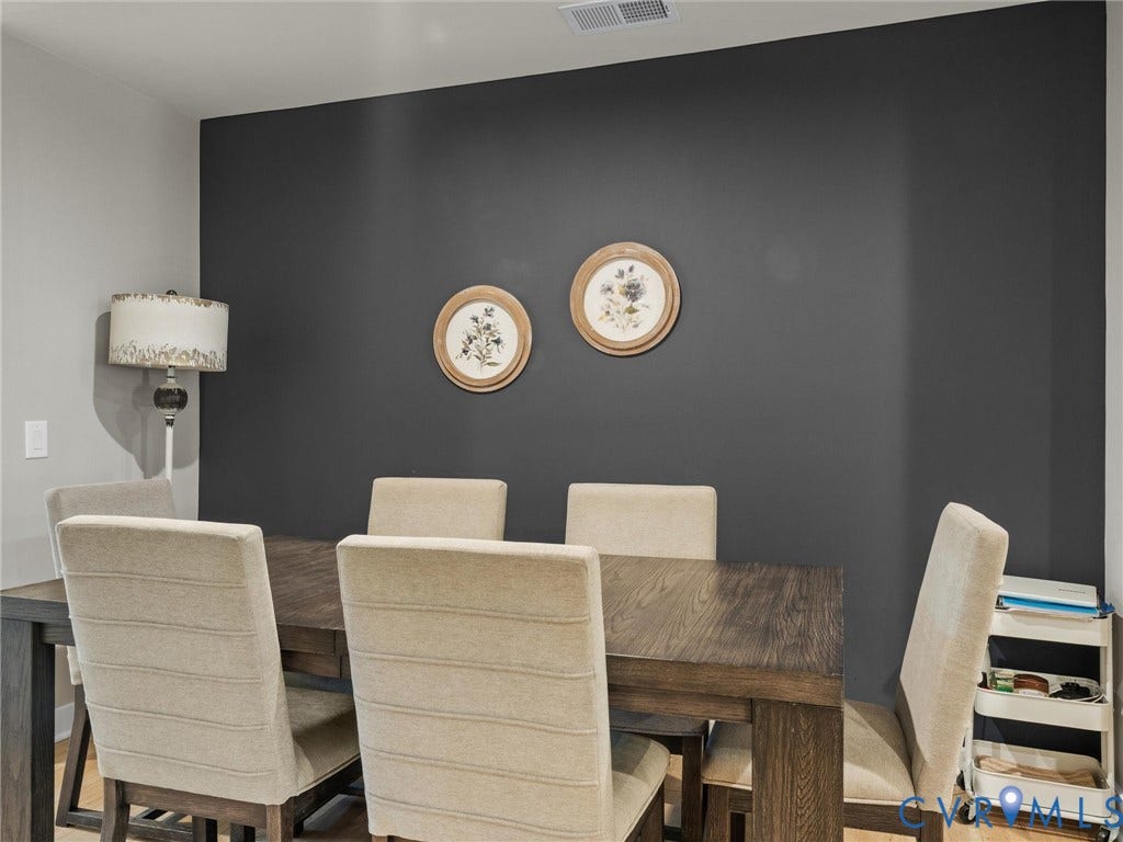 Wood-finish dining table with six upholstered chairs