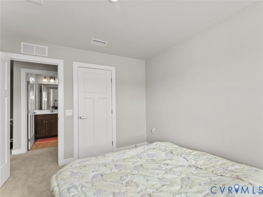 Neutral wall finishes, recessed lighting, and carpeted flooring