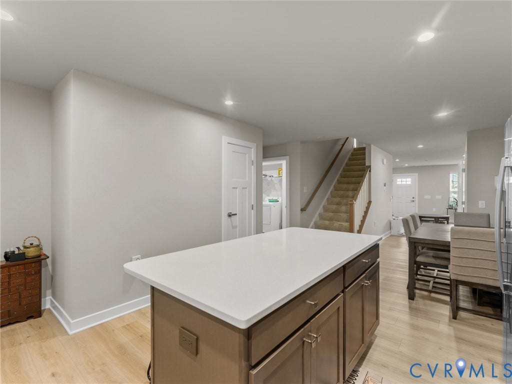 Kitchen island featuring a white countertop and wood-finish cabinetry