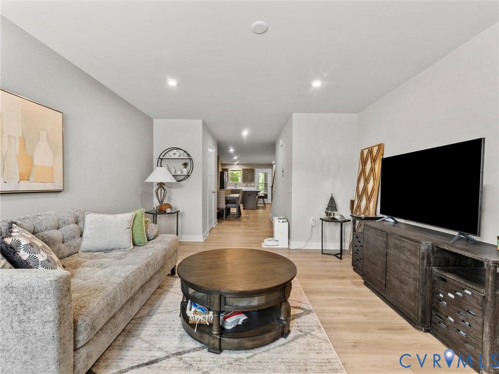 Recessed lighting, light wood-finish flooring, and neutral wall tones