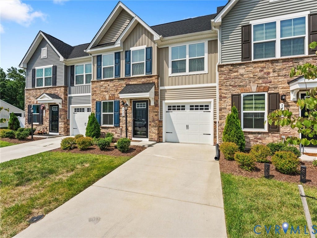 Stone veneer and siding exterior with dark shutters