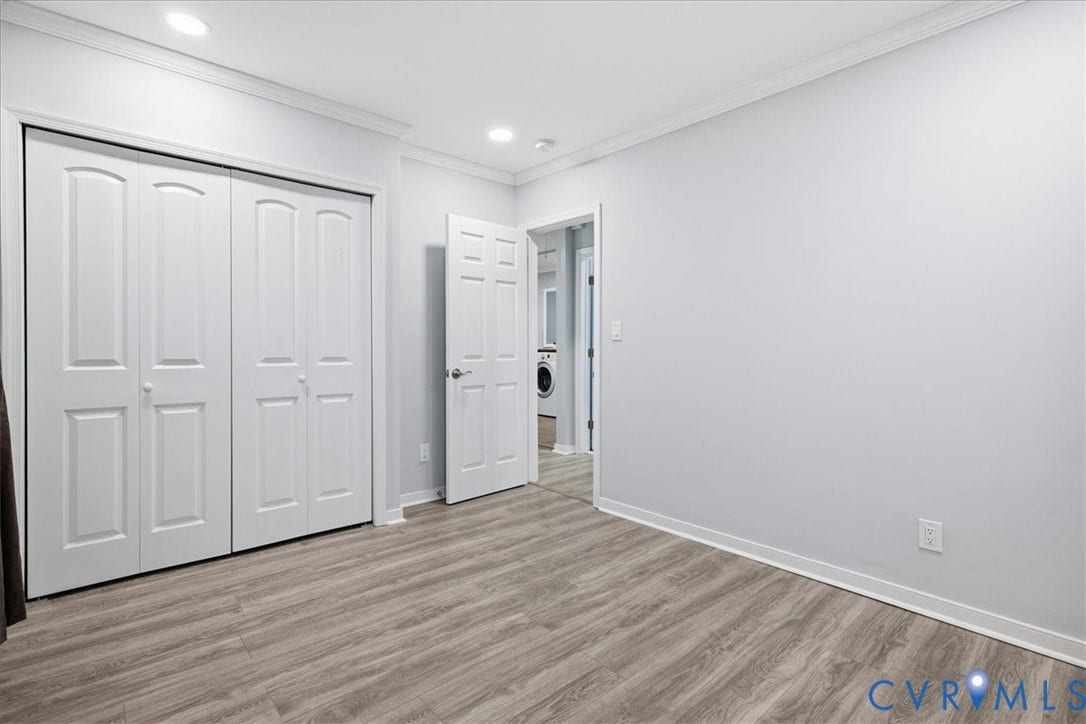 1630 W Washington Street, Petersburg, VA 23803 Wood-finish flooring, recessed lighting, crown molding, white bi-fold closet doors, and white interior doors