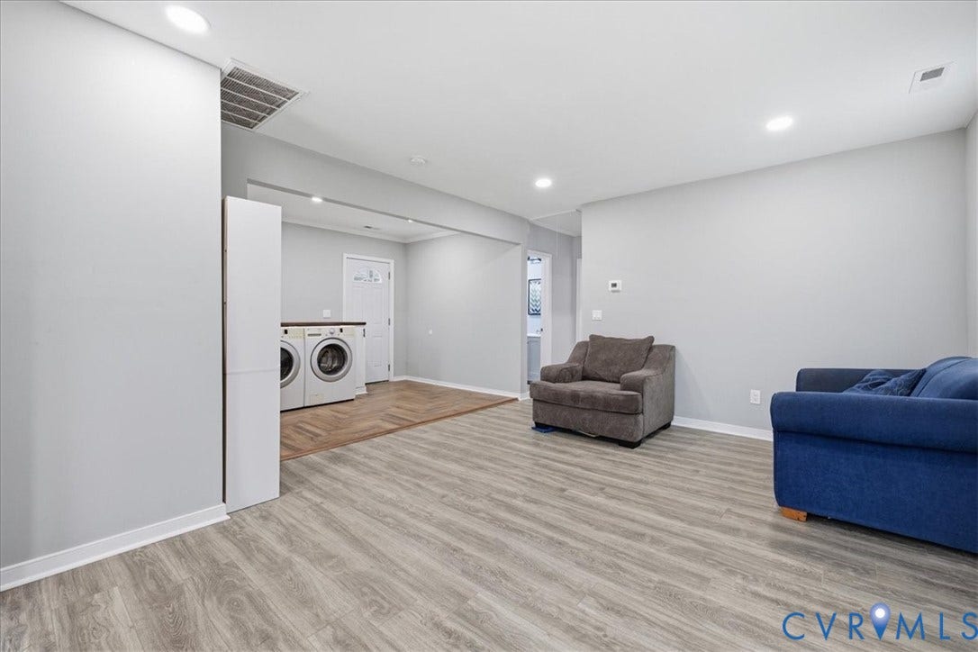 1630 W Washington Street, Petersburg, VA 23803 Spacious interior featuring wood-finish flooring, recessed lighting, light gray wall paint, and a laundry area with built-in countertop