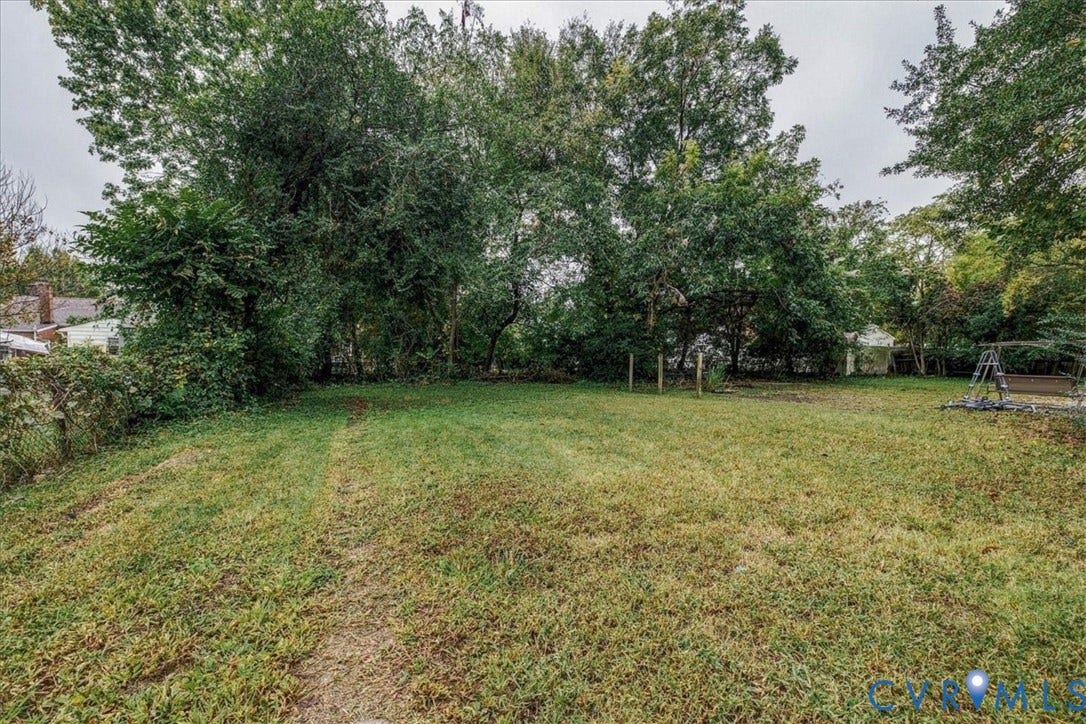 1630 W Washington Street, Petersburg, VA 23803 Expansive lawn area with mature trees and partial fencing