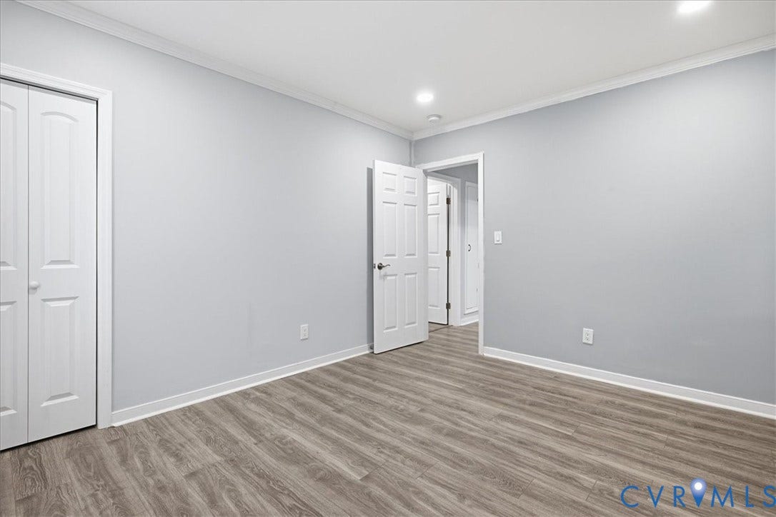 1630 W Washington Street, Petersburg, VA 23803 Light gray wall paint, crown molding, wood-finish flooring, two-panel interior doors, recessed ceiling lighting