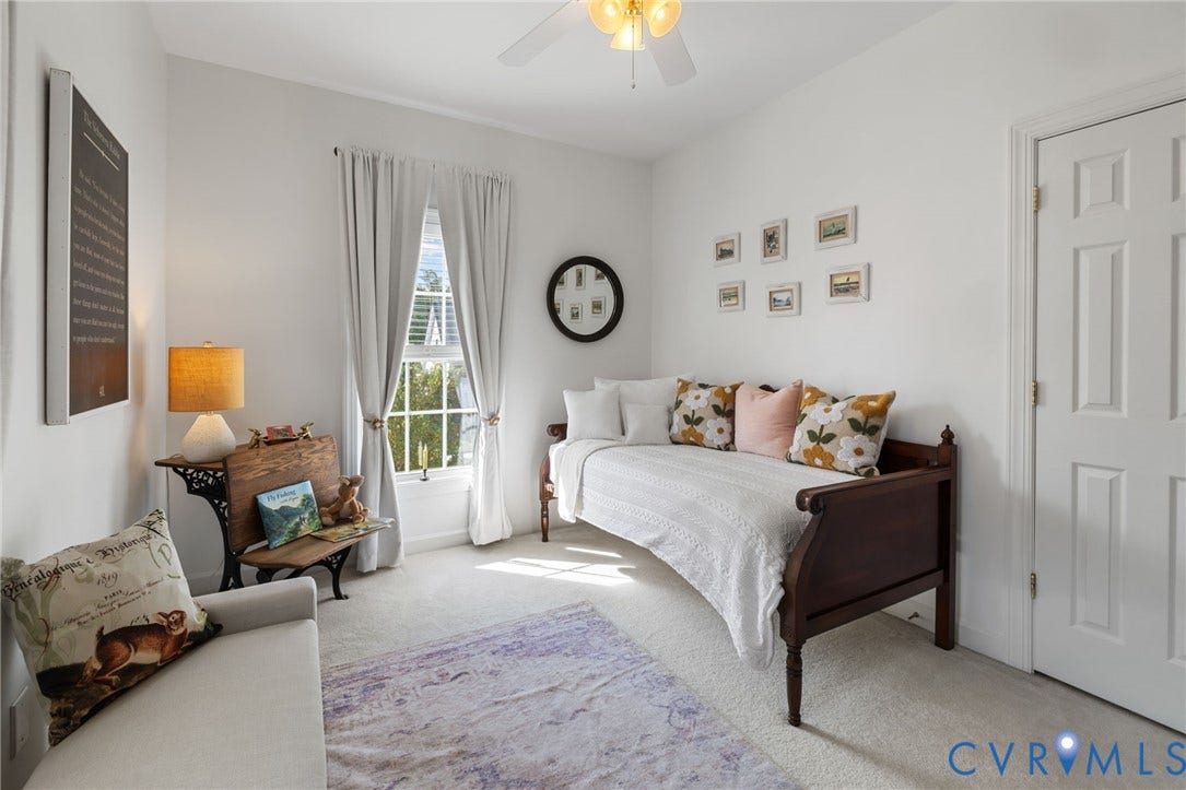 White painted walls, light-toned carpet, a ceiling fan with integrated lighting, a multi-pane window, and a paneled door