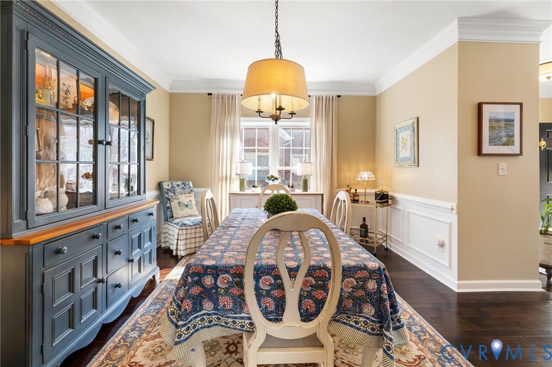 Hardwood flooring, crown molding, chair rail, pendant lighting, and a built-in display cabinet
