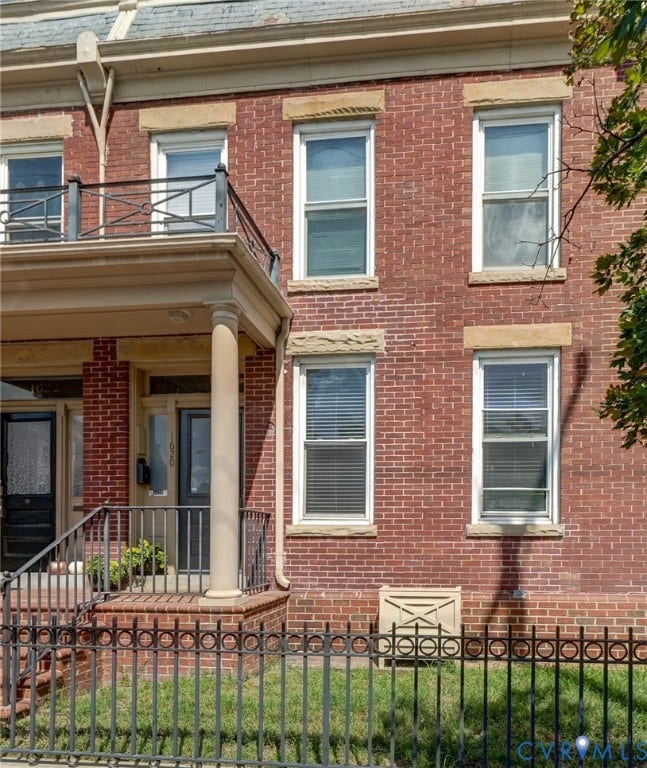 1620 W Cary Street, Fan Extenstion, Richmond, VA 23220 Brick facade with stone window sills, slate-style roof, and a decorative wrought iron fence