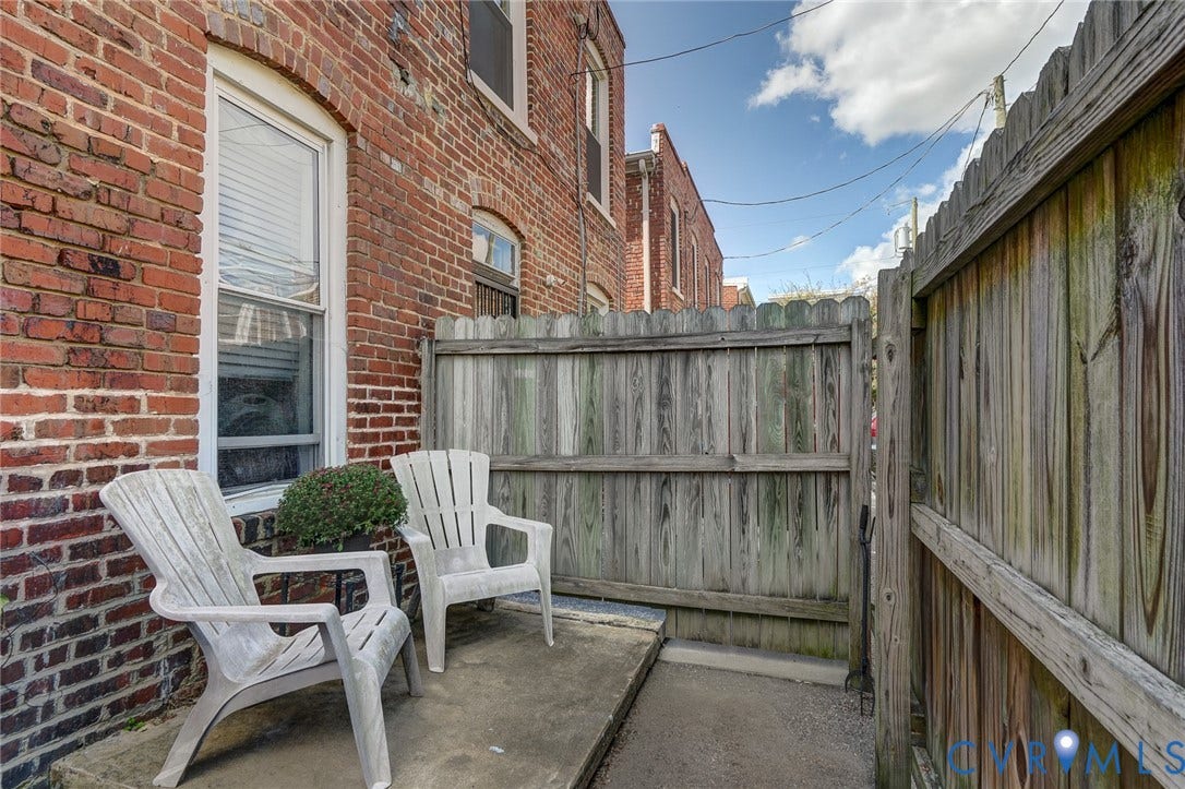 1620 W Cary Street, Fan Extenstion, Richmond, VA 23220 Brick exterior with white window trim and a wood plank fence