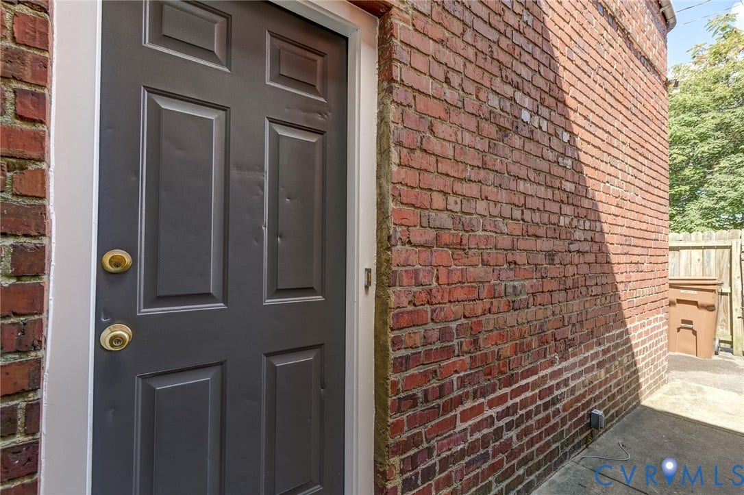 1620 W Cary Street, Fan Extenstion, Richmond, VA 23220 Brick exterior with a paneled entry door and a concrete pathway