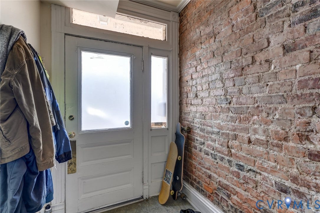 1620 W Cary Street, Fan Extenstion, Richmond, VA 23220 Entryway with an exposed brick wall, a white panel door, and a transom window