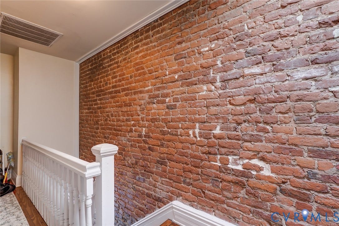 1620 W Cary Street, Fan Extenstion, Richmond, VA 23220 Exposed brick wall, crisp white crown molding, white painted balusters, and wood-finish flooring