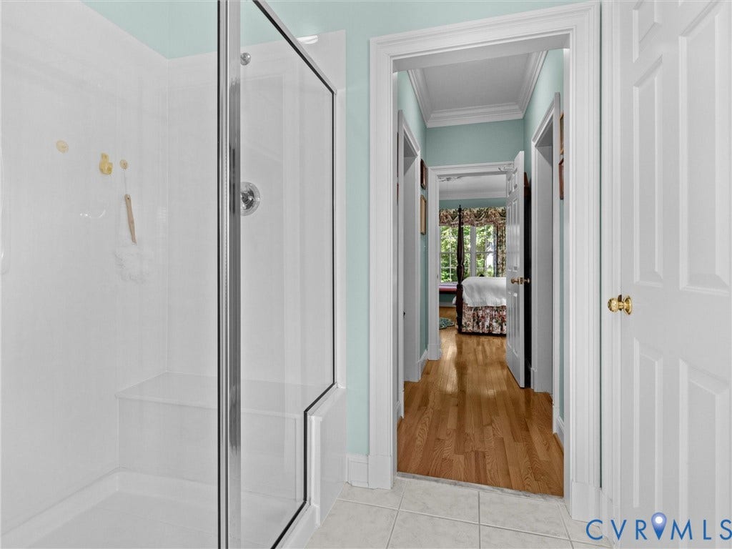 Walk-in shower with a built-in bench and glass enclosure